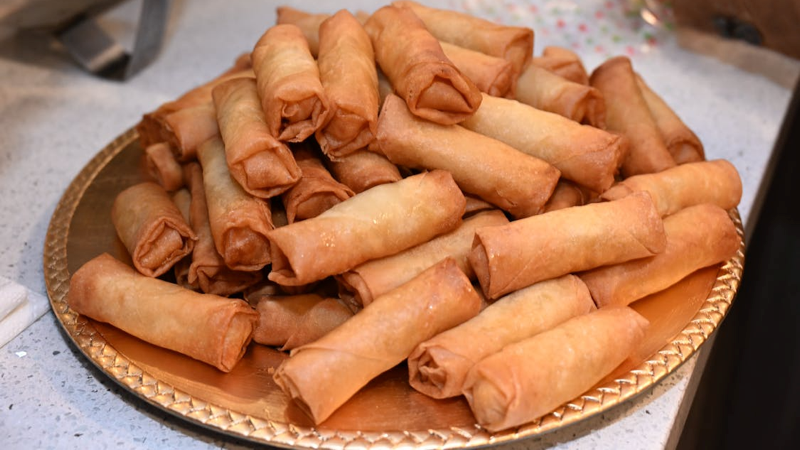 Spring rolls are a traditional Chinese snack made with thin wrappers and fresh fillings, symbolizing the arrival of spring and new beginnings.